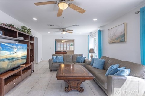 A living room with a brown coffee table and a grey couch.