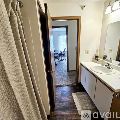 A bathroom with a white sink and a mirror.