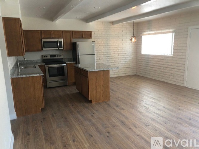 A kitchen with wooden cabinets and a white refrigerator.