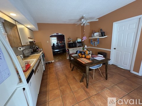 A kitchen with a table and chairs in the middle of the room.