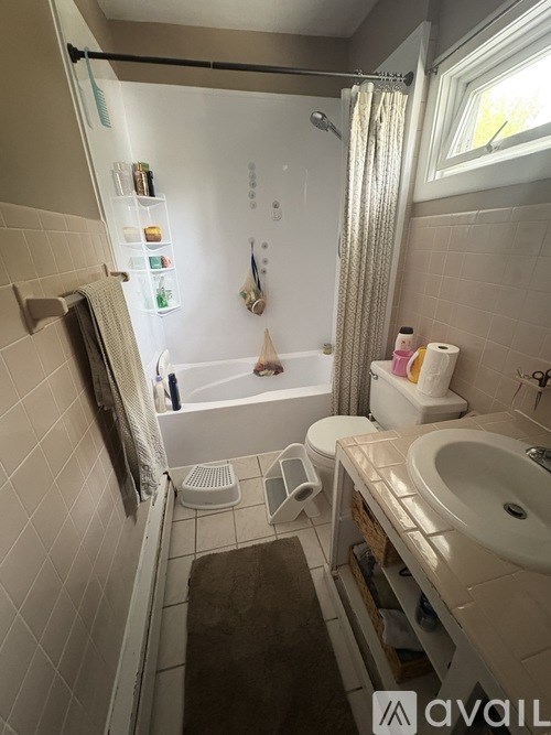 A bathroom with a white sink, toilet, and bathtub.