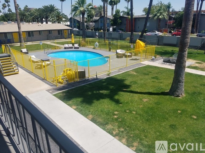 A pool surrounded by a yellow fence.