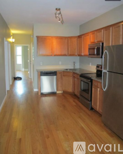 A kitchen with wooden floors and stainless steel appliances.