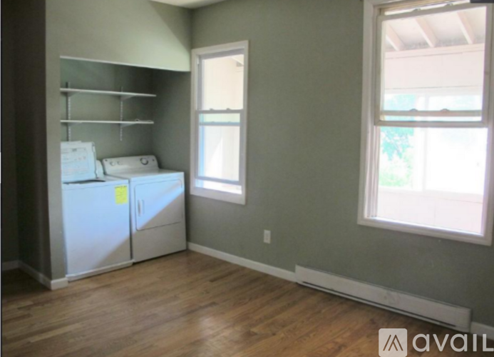 A kitchen with a white fridge and a window.