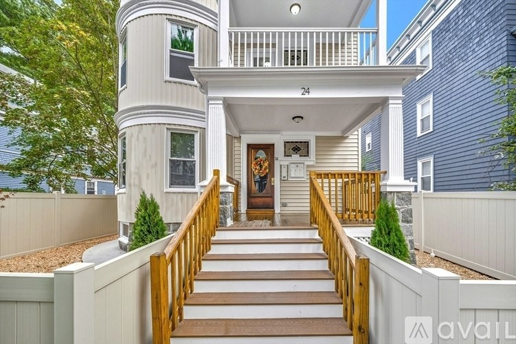 A house numbered 24 with a wooden staircase leading to the front door.