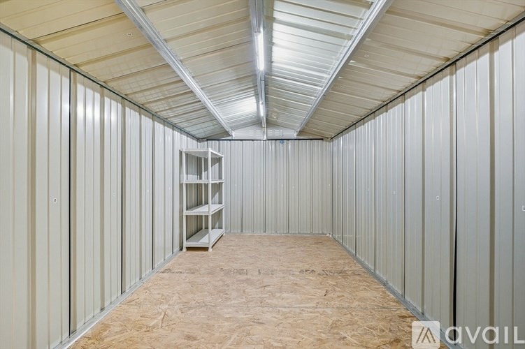 A sparsely furnished room with a ladder in the middle.