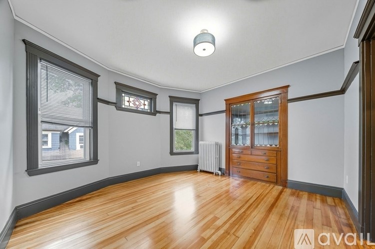 A room with wooden floors and a large window.