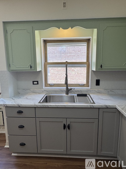 A kitchen with a sink and cabinets.