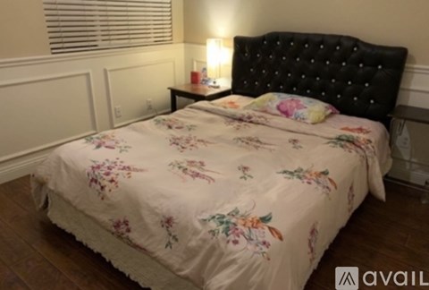 A bed with a floral comforter is in the image.