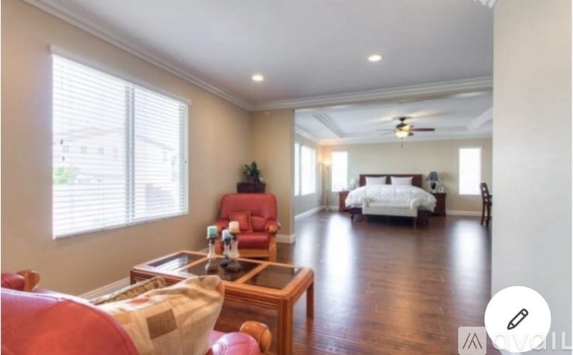 A living room with a red chair and a wooden coffee table.
