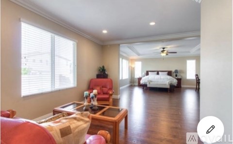 A living room with a red chair and a wooden coffee table.