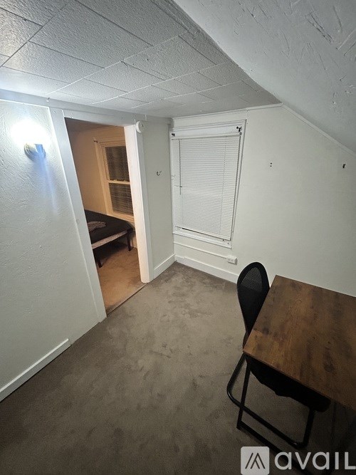 A room with a table and a chair in it.