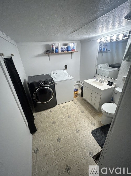 A small bathroom with a washer and dryer.