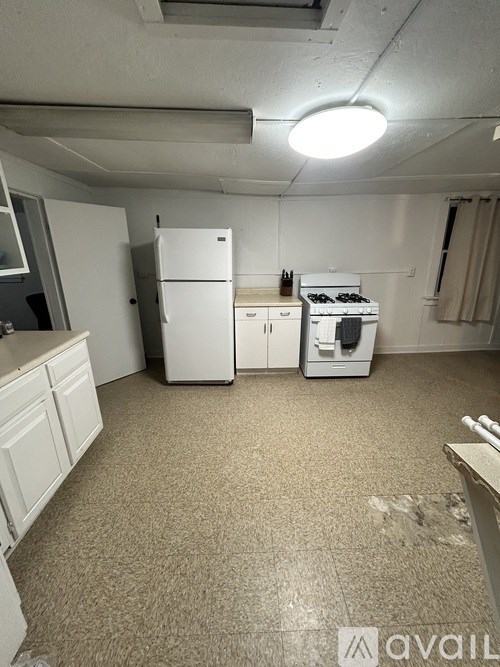 A kitchen with a white fridge and stove.