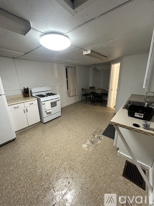 A kitchen with white appliances and a white ceiling.