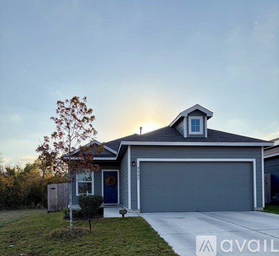 A house with a blue door and a garage door.