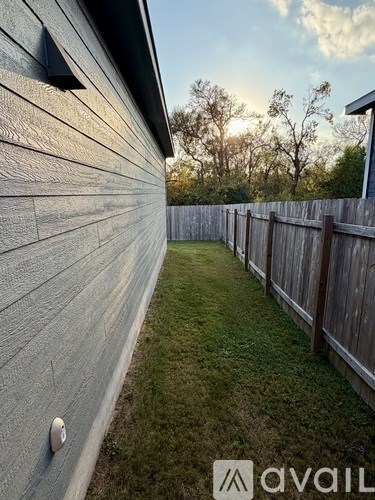 A wooden fence and a wall with a vent on it.