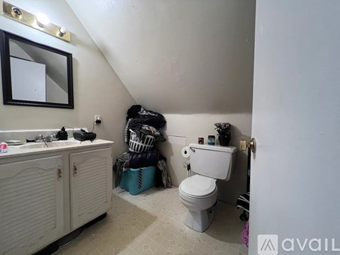 A bathroom with a white toilet and a white sink.