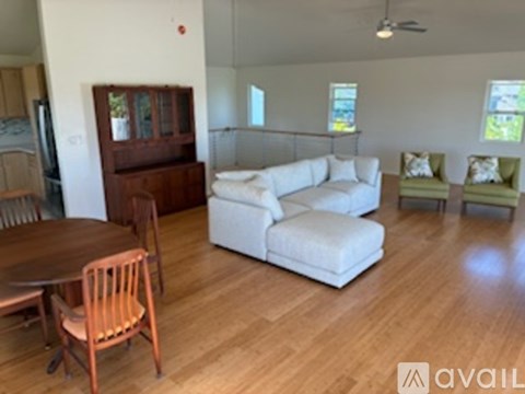A living room with a white couch and a wooden table.