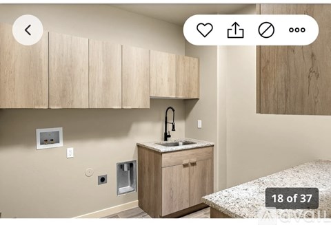 A kitchen with wooden cabinets and a granite countertop.