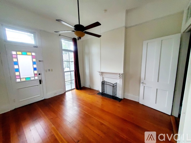 A room with wooden floors and a fireplace.