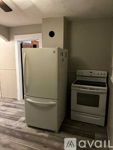 A white refrigerator and oven in a kitchen.