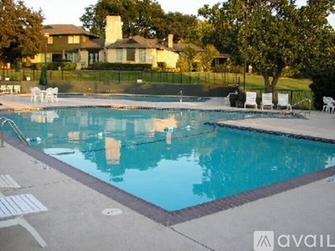 A swimming pool with a house in the background.