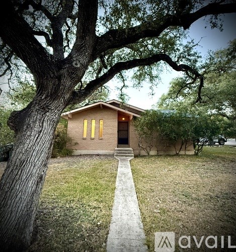 A house with a tree in front of it.