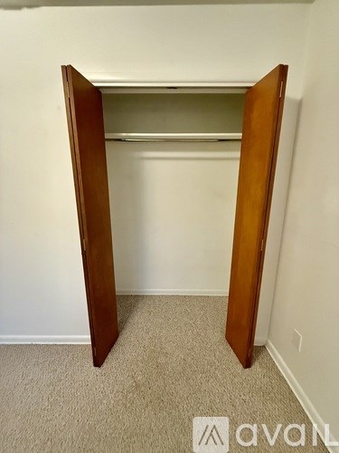 A wooden closet with a shelf inside.