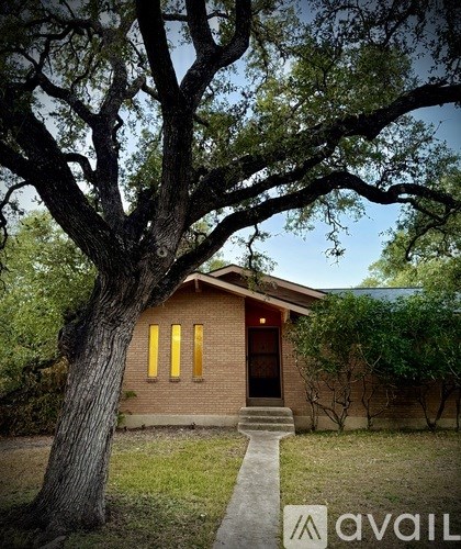 A house with a tree in front of it.