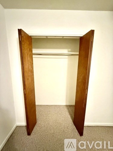 A room with a carpeted floor and a white wall.