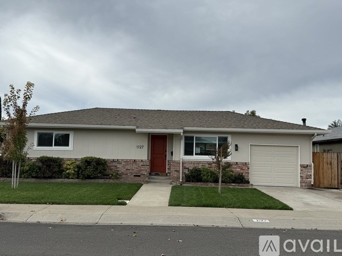 A house with a brown door is located at 1127.