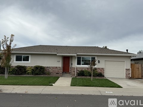 A house with a brown door is located at 1127.