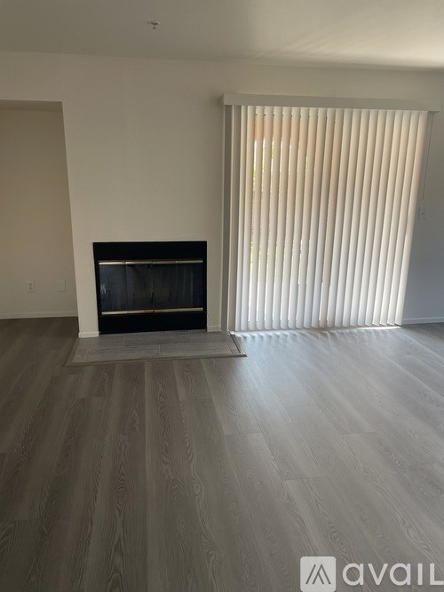 A room with a fireplace and a sliding door.