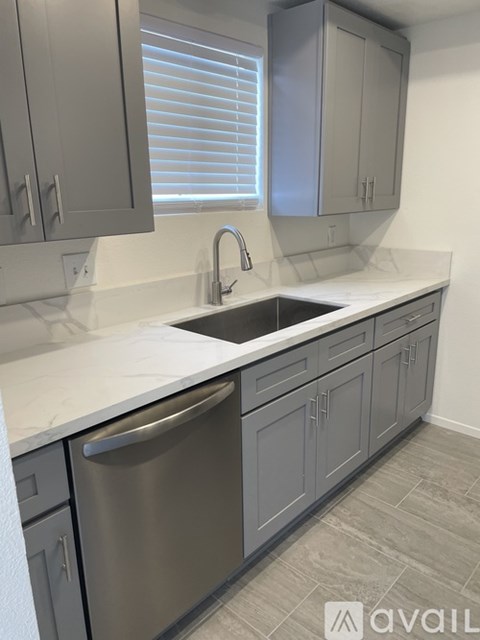 A kitchen with a sink and a dishwasher.