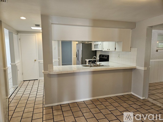 A kitchen area with a counter and a sink.