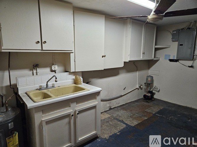 A kitchen with a sink and cabinets.