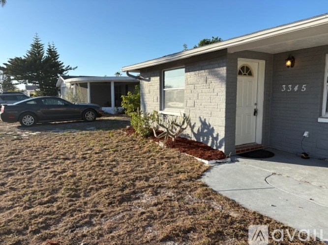 A house numbered 3345 with a car parked in front.
