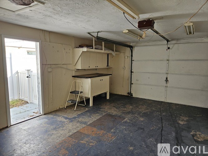 A room with a bunk bed and desk in it.