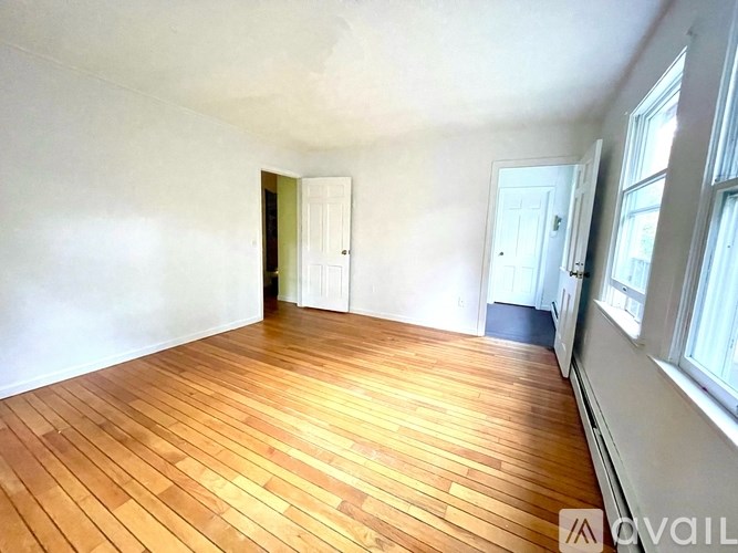 A room with wooden floors and white walls.