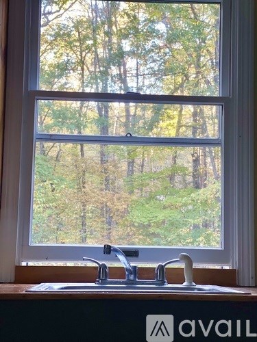 A window with a sink in front of it and a logo that says "avaiL" on the bottom.