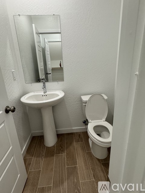 A white sink and toilet in a small bathroom.