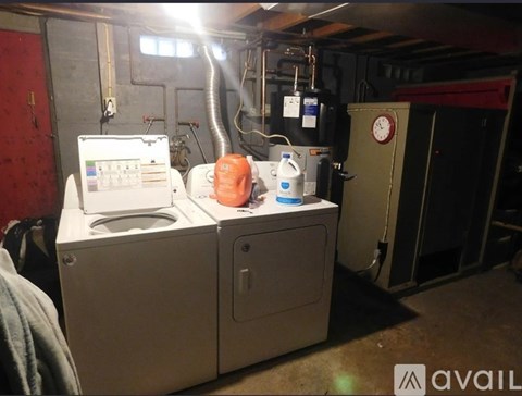 A washing machine and dryer are in a basement.