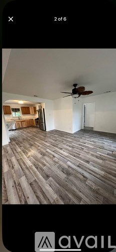A room with wooden flooring and a ceiling fan.