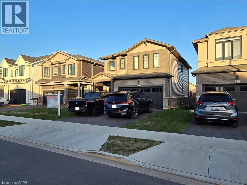 A row of houses with cars parked in front.