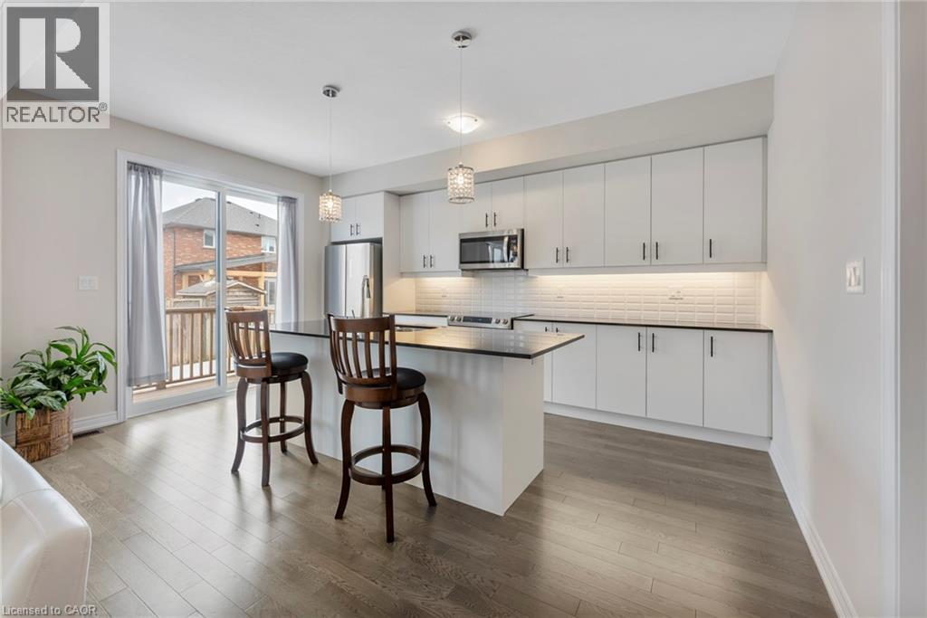 A modern kitchen with white cabinets and a wooden island.