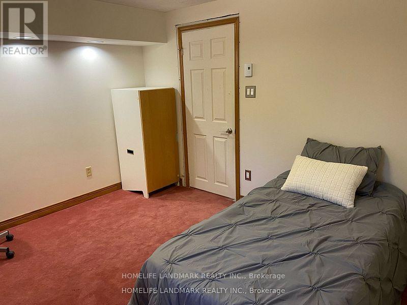 A bedroom with a bed, dresser, and closet.