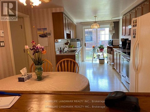 A kitchen with a table and chairs in the middle of the room.