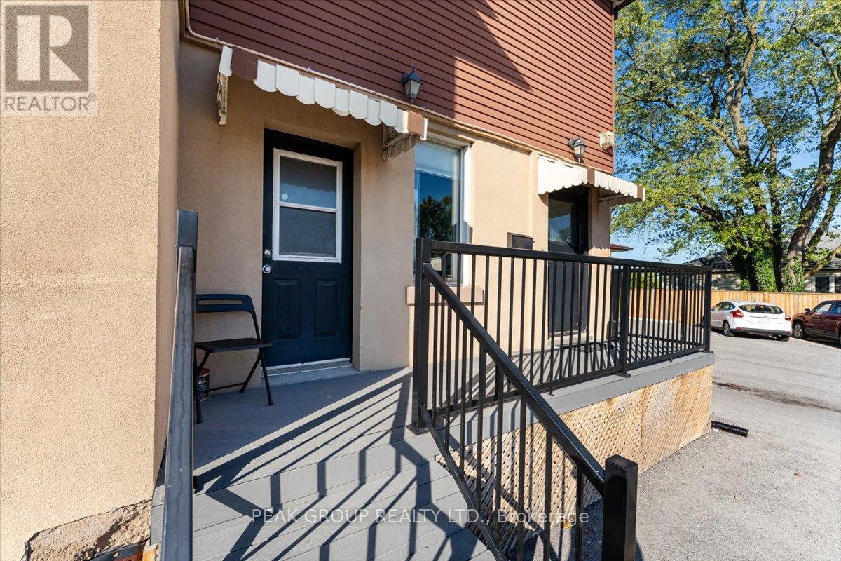 A house with a black door and a black railing.