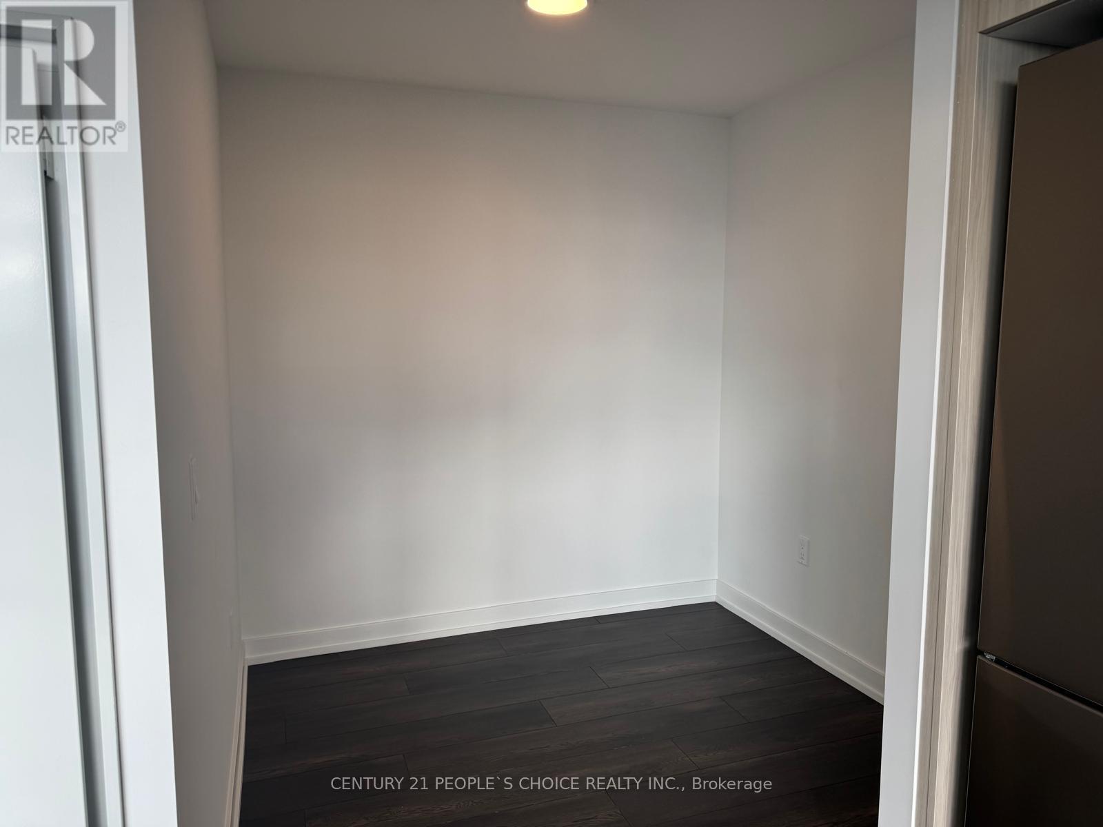 A room with a wooden floor and white walls.